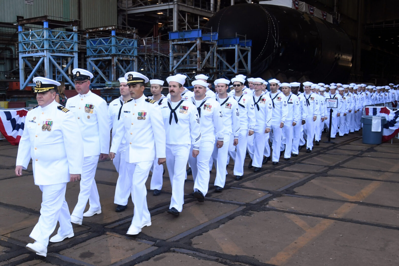 210731-N-GR655-002 GROTON, Conn. (July 31, 2021) – The crew of the pre-commissioning unit (PCU) Hyman G. Rickover (SSN 795) march in formation during a christening ceremony at General Dynamics Electric Boat shipyard facility in Groton, Conn., July 31, 2021. Rickover and crew will operate under Submarine Squadron (SUBRON) FOUR whose primary mission is to provide attack submarines that are ready, willing, and able to meet the unique challenges of undersea combat and deployed operations in unforgiving environments across the globe. (U.S. Navy photo by Chief Petty Officer Joshua Karsten/RELEASED)