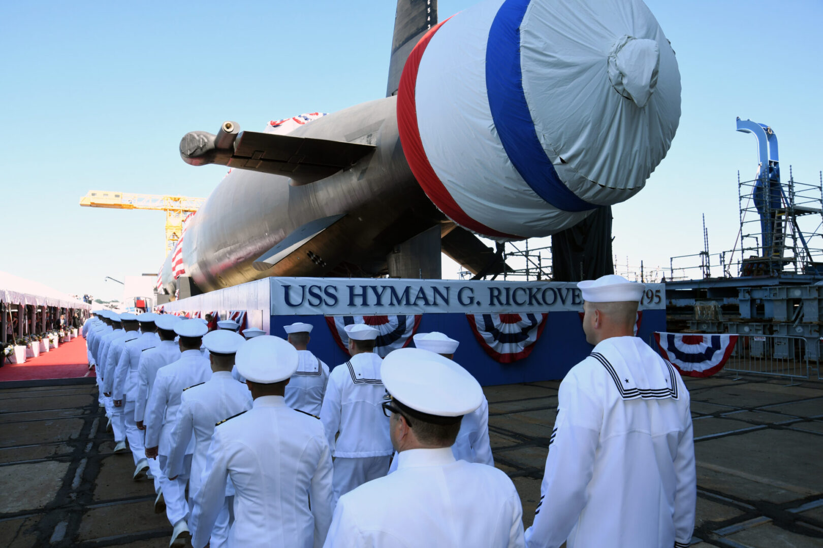 210731-N-GR655-014 GROTON, Conn. (July 31, 2021) – The crew of the pre-commissioning unit (PCU) Hyman G. Rickover (SSN 795) march in formation during a christening ceremony at General Dynamics Electric Boat shipyard facility in Groton, Conn., July 31, 2021. Rickover and crew will operate under Submarine Squadron (SUBRON) FOUR whose primary mission is to provide attack submarines that are ready, willing, and able to meet the unique challenges of undersea combat and deployed operations in unforgiving environments across the globe. (U.S. Navy photo by Chief Petty Officer Joshua Karsten/RELEASED)
