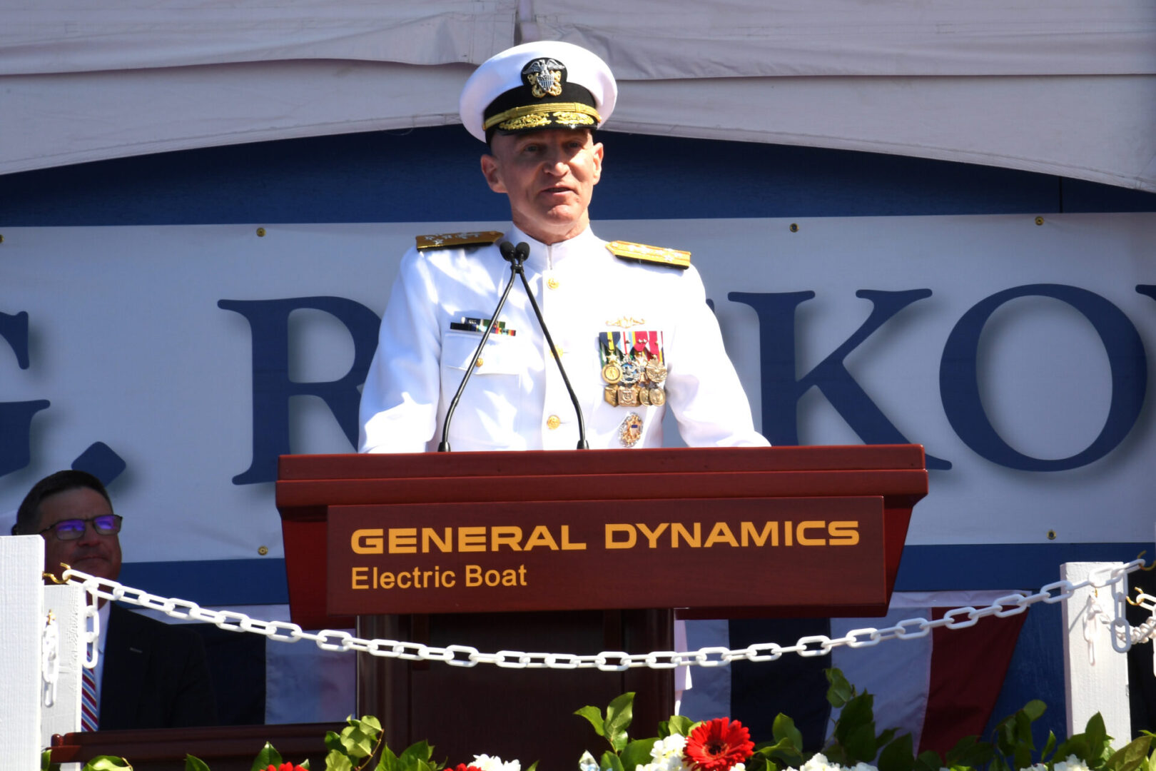 210731-N-GR655-134 GROTON, Conn. (July 31, 2021) – Adm. James Caldwell, Jr., director of the Naval Nuclear Propulsion Program, delivers remarks in front of the pre-commissioning unit (PCU) Hyman G. Rickover (SSN 795) during a christening ceremony at General Dynamics Electric Boat shipyard facility in Groton, Conn., July 31, 2021. Rickover and crew will operate under Submarine Squadron (SUBRON) FOUR whose primary mission is to provide attack submarines that are ready, willing, and able to meet the unique challenges of undersea combat and deployed operations in unforgiving environments across the globe. (U.S. Navy photo by Chief Petty Officer Joshua Karsten/RELEASED)