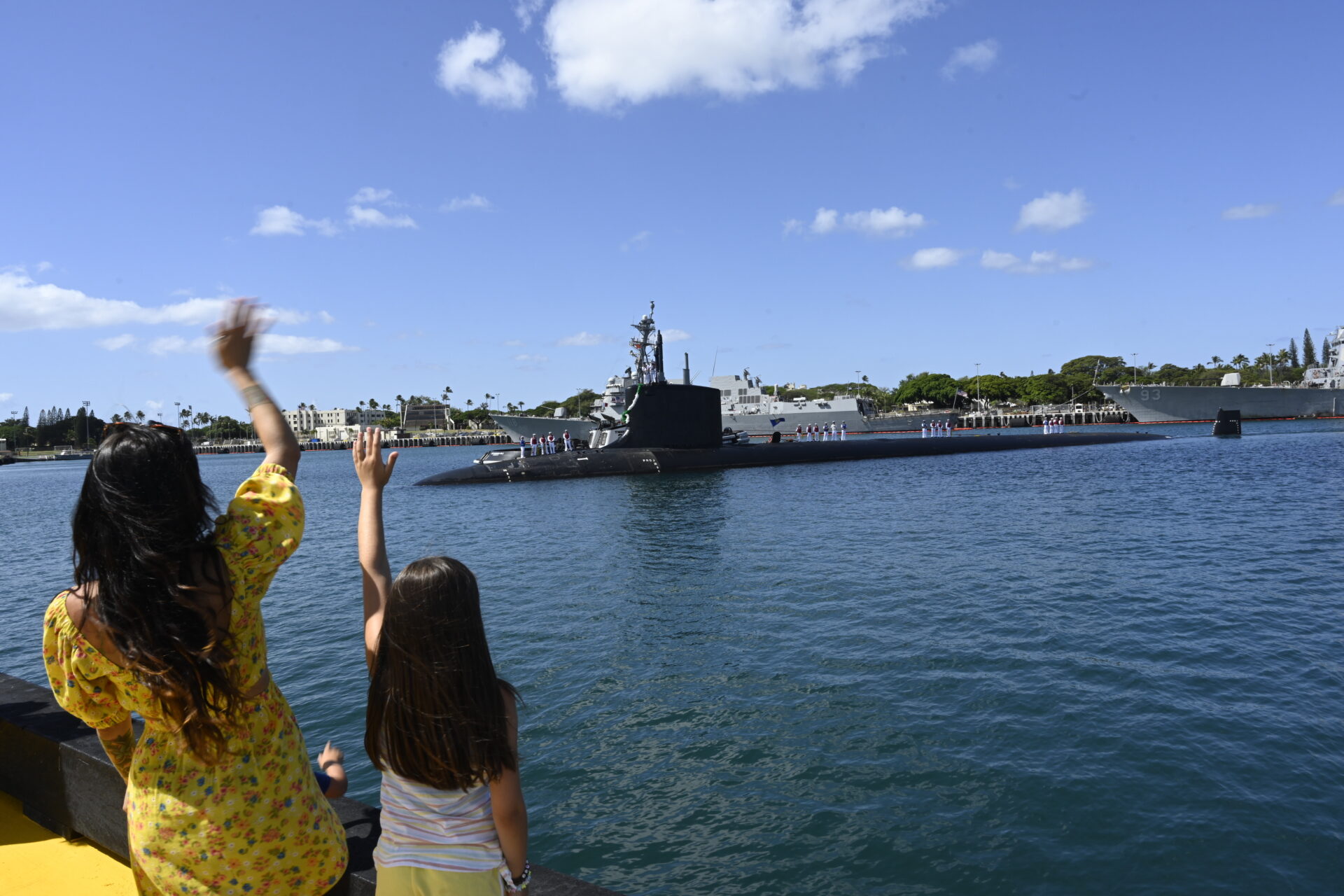 PEARL HARBOR (July 27, 2023) Family members greet the Virginia-class fast-attack submarine USS Vermont (SSN 792) as it arrives at its new homeport of Joint Base Pearl Harbor-Hickam, July 27, 2023. Vermont, the first Block IV Virginia-class submarine to enter service, is a new construction submarine that is joining the six Virginia-class submarines already assigned to Commander, Submarine Squadron (CSS) 1. (U.S. Navy photo/video by Chief Mass Communication Specialist Amy Biller)